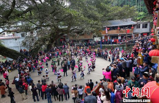 广西苗寨芦笙踩堂引游客围观